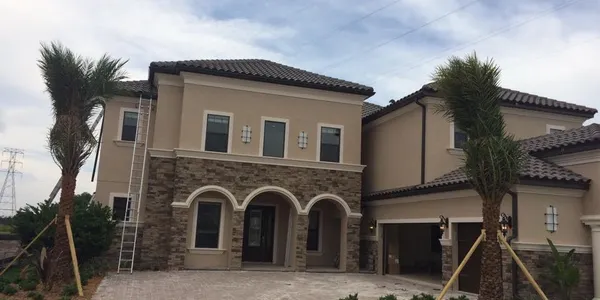 Downspout directing stormwater away from landscaping and a Tampa Bay home